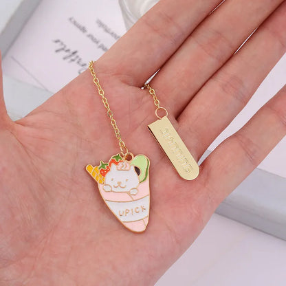 Jane Lime Foodie cat creative metal bookmark with cartoon pendant on a book page.