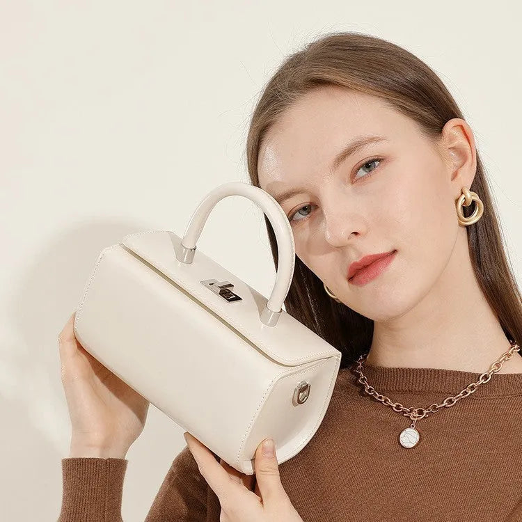 One-shoulder crossbody women's bag in genuine cowhide leather with medium hardness urban simplicity design, available in black, brown, milky white, and red colours for everyday carry and daily configuration needs