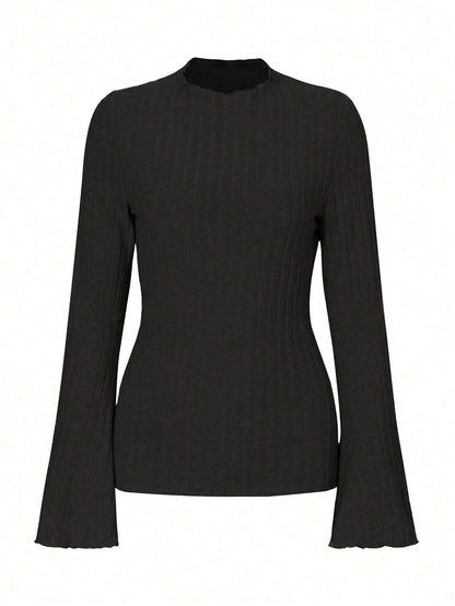 Long sleeve round neck top in black with lantern sleeves and slim fit, on a hanger