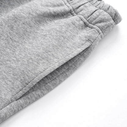 Men's straight-leg grey cotton casual trousers with an elasticated waistband laid flat.
