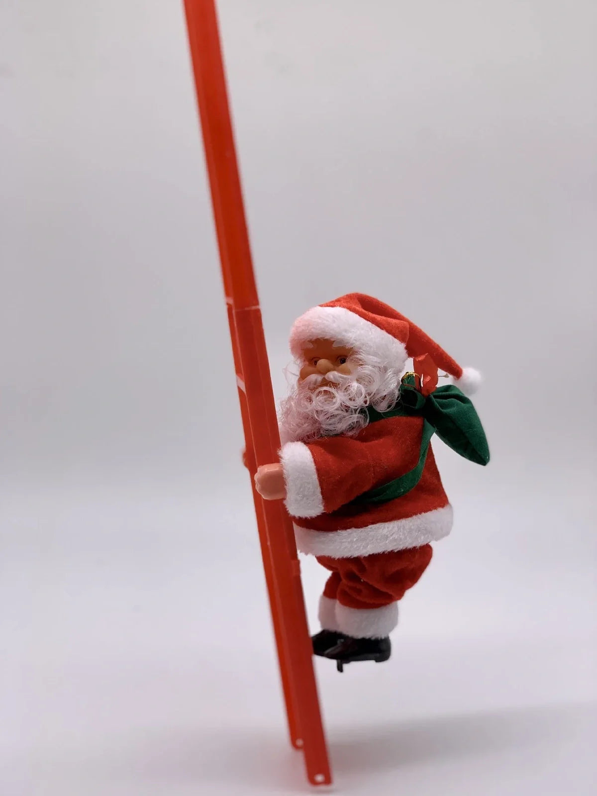 Electric Santa Claus climbing ladder decoration measuring 20cm tall with continuous motion mechanism