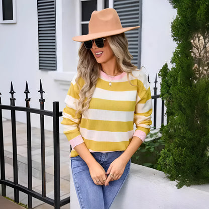 Women's loose fit striped long sleeve round neck sweater on a hanger.