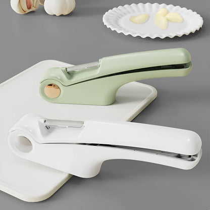 White manual garlic press with stainless steel mechanism on wooden kitchen surface