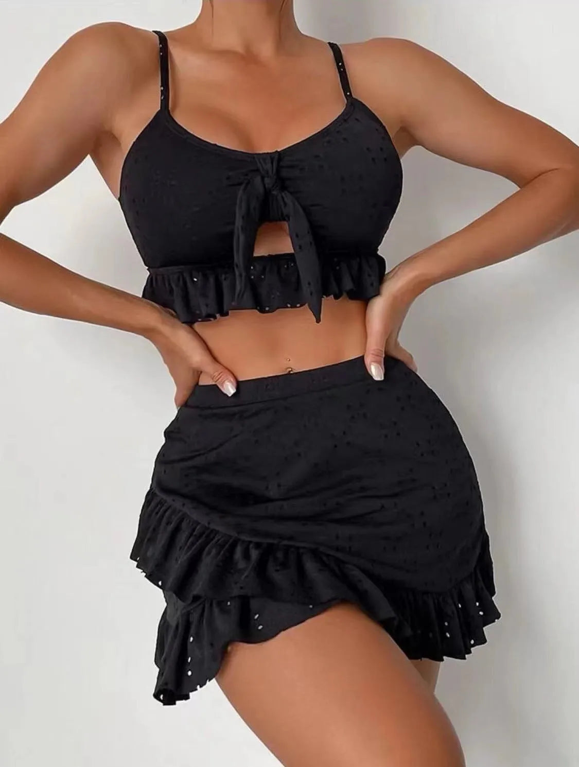 Women's white split hip skirt three-piece bikini swimsuit set on a mannequin.