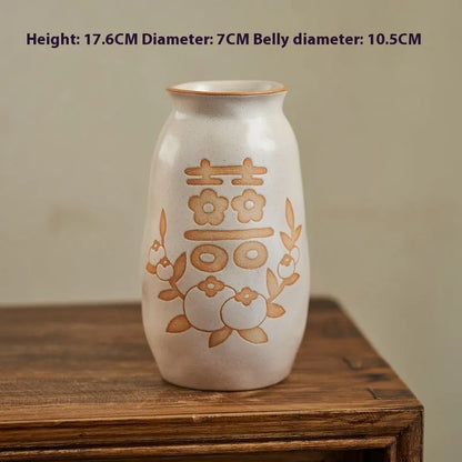 Hand-painted Chinese ceramic vase with carved detail on a desk, shown in Double Happiness colour design.
