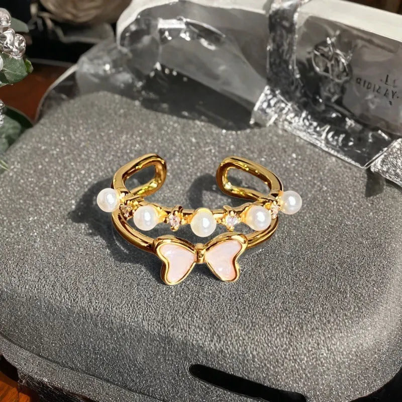Adjustable copper gourd ring with zircon stones showing flower and bow design elements