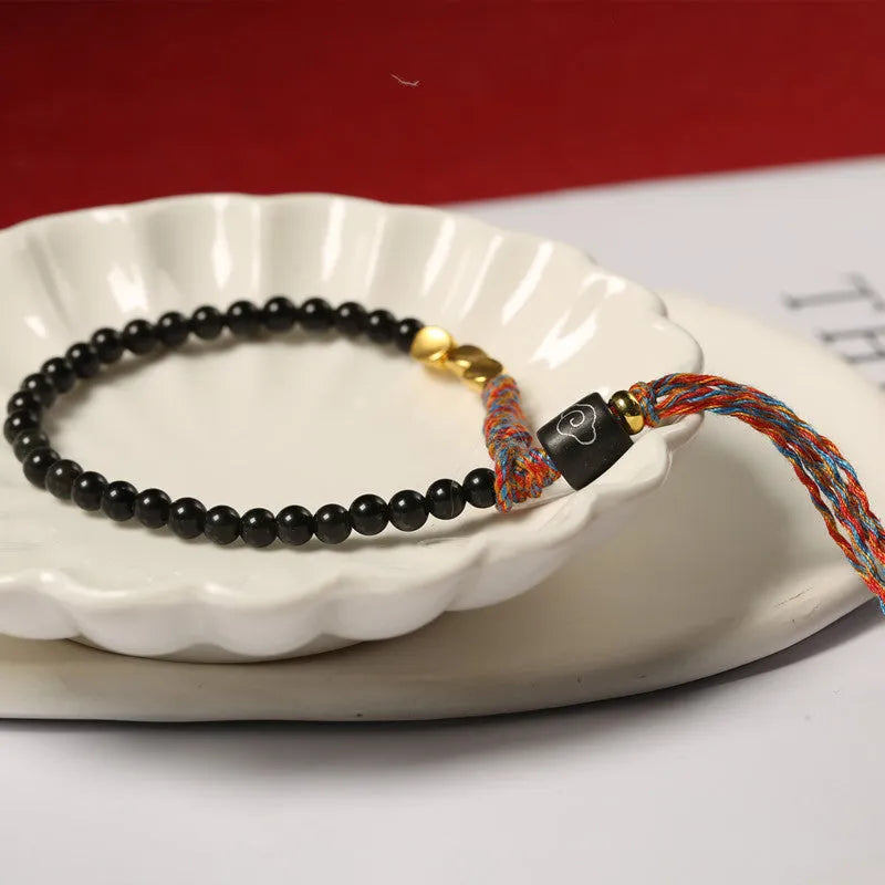 Hand-woven obsidian carrying strap showing woven texture and 4mm width