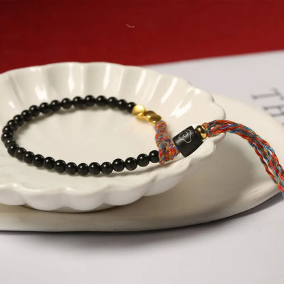 Hand-woven obsidian carrying strap showing woven texture and 4mm width