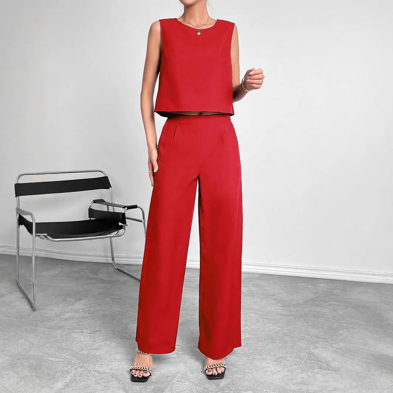 Round neck sleeveless top and wide leg pants two-piece set in red or navy blue, available in sizes S to XXL with a 100% polyester fabric composition for easy care and versatile styling.