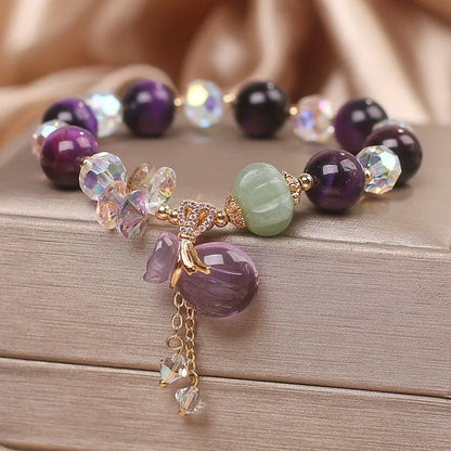 Women's forest style crystal bracelet with purple tigereye money bag pendant and rhinestone details