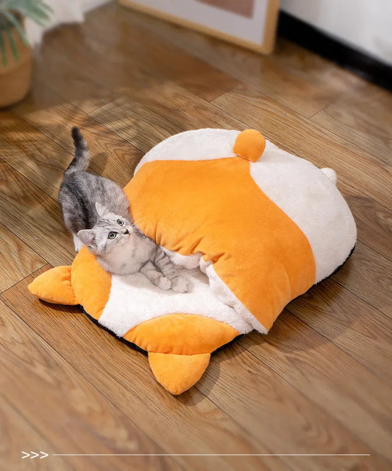 Orange semi-closed sleeping bag bed for cats on a floor, showing soft interior and dimensions.