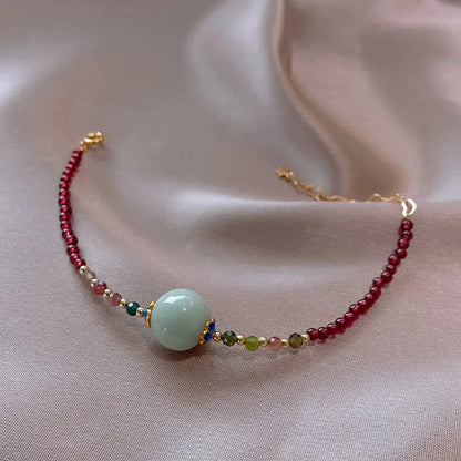 Aquamarine coloured drop shape tourmaline bracelet with garnet electroplated finish
