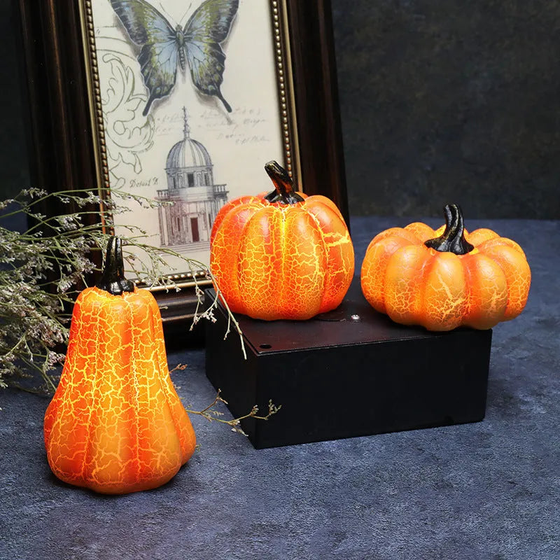Set of three resin Halloween pumpkin lanterns with LED lights in long, medium, and short sizes.
