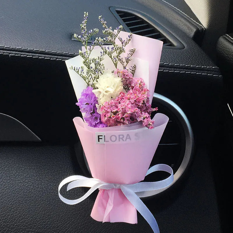 Mini dried flower bouquet mounted in car air vent for decorative aromatherapy