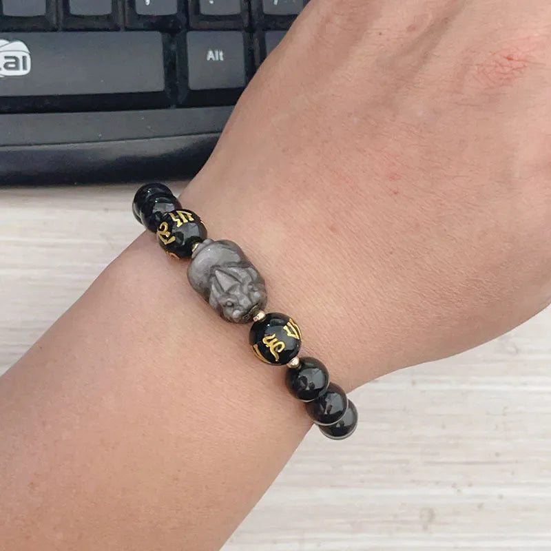 Men's silver stone bracelet with engraved proverb beads and Chinese zodiac style on a wrist.