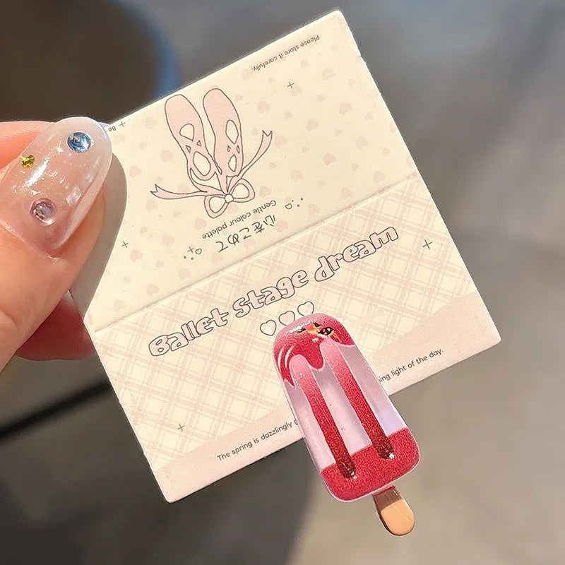 A resin hair barrette with a cartoon ice cream charm on a side-clip, shown in a pink colour variant.
