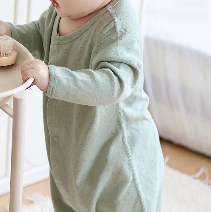Pure cotton baby romper in blue with long sleeves and single-breasted closure, showing long climbing style design
