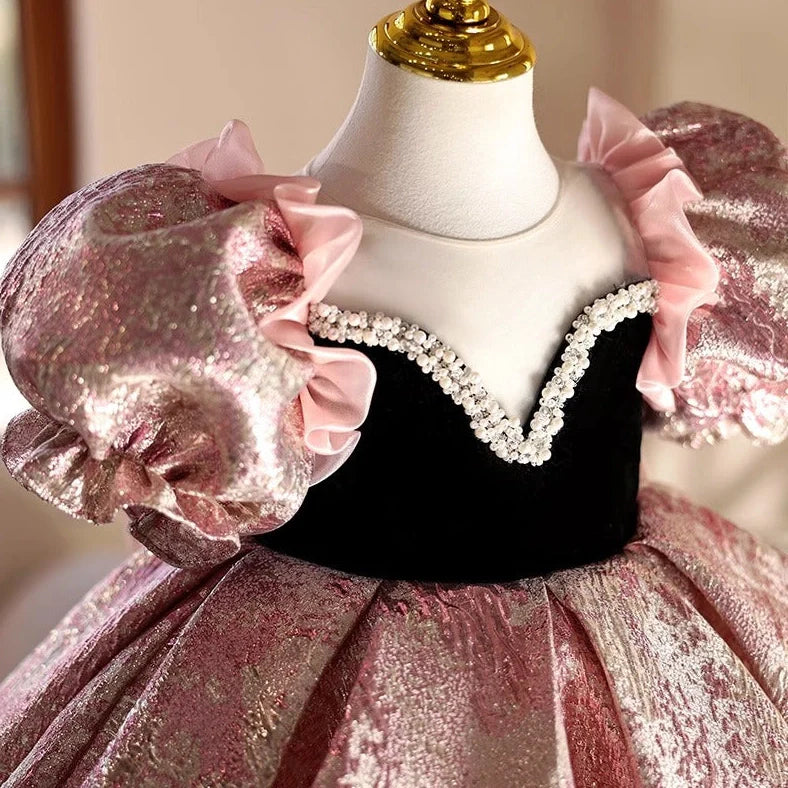 Pink children's princess dress with cute design elements, shown on hanger