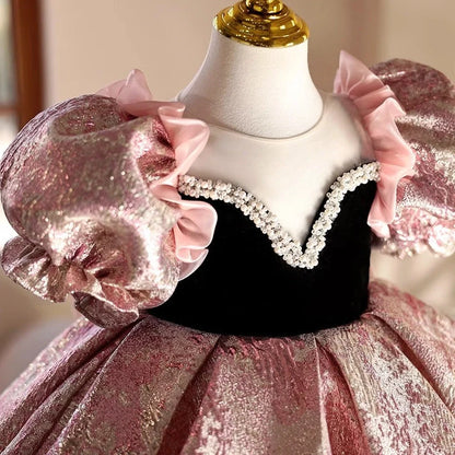 Pink children's princess dress with cute design elements, shown on hanger