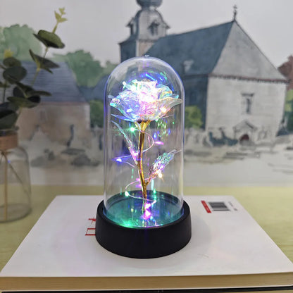 Glass cover small night lamp with plastic flowers, 15cm height, black base, showing colour light options