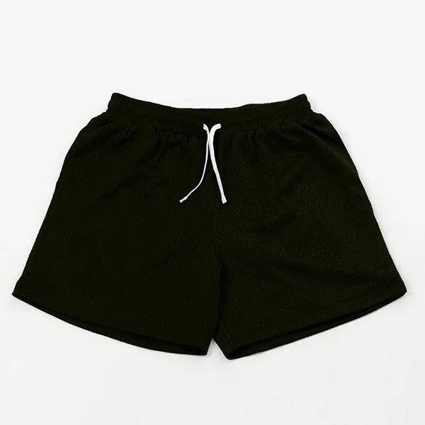 Men's black athletic shorts with grey mesh side panels for breathability, laid flat on a surface.