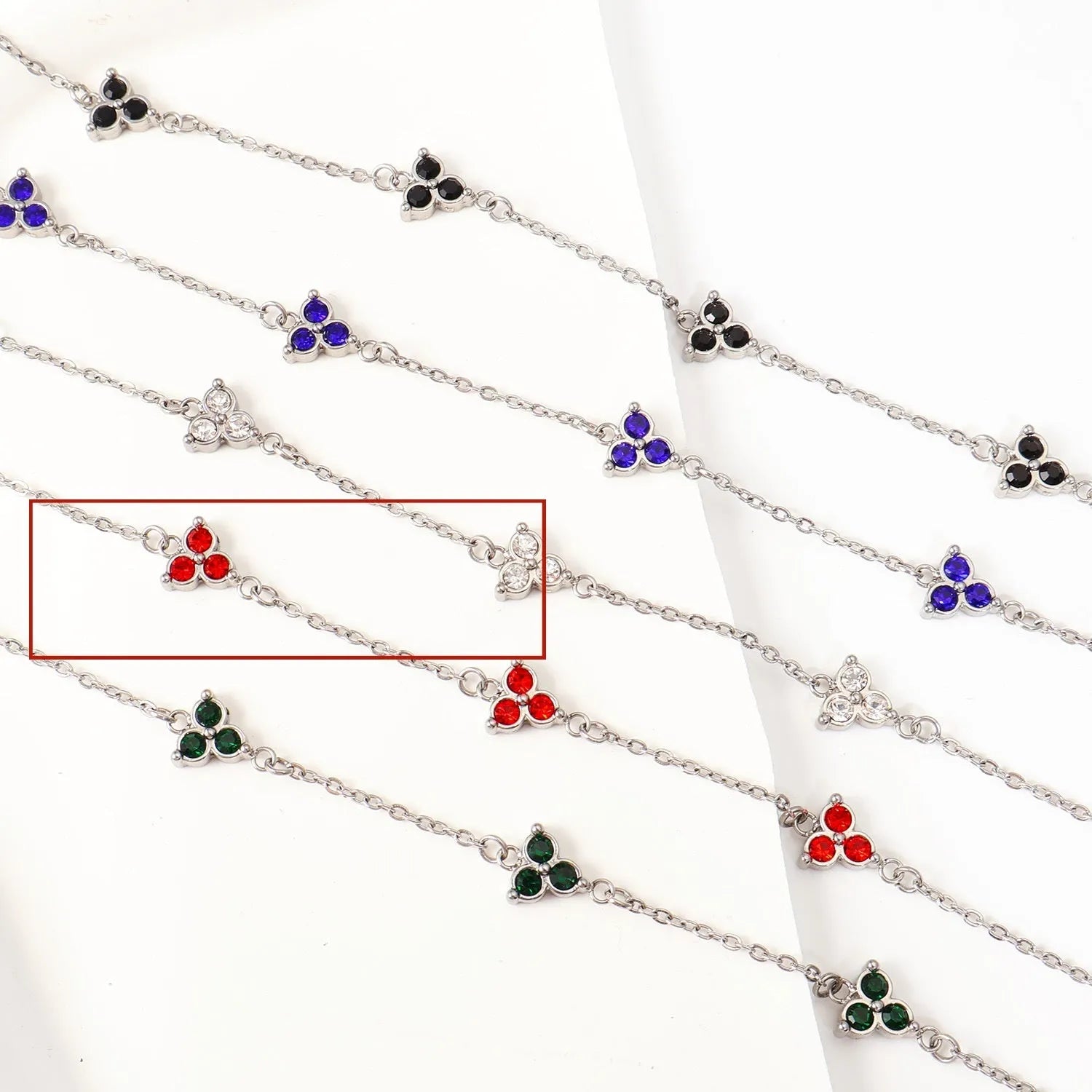 Women's stainless steel bracelet with three triangle-shaped charms in different coloured stone settings