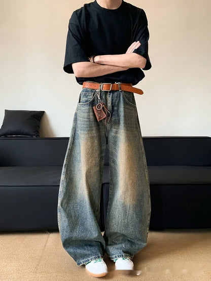 Man wearing retro blue distressed slim-fit jeans with a wide-leg cut.