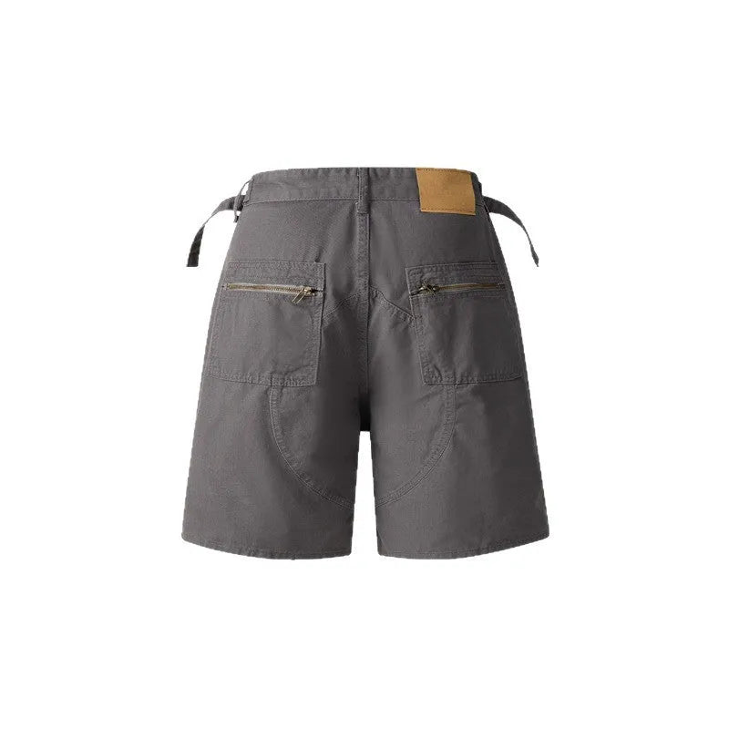 Retro loose-fit washed cotton workwear shorts in camouflage green colour with zip fly.