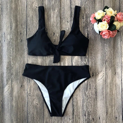 Women's two-piece bikini set in a solid colour on a white background, showing sleeveless bra and briefs.