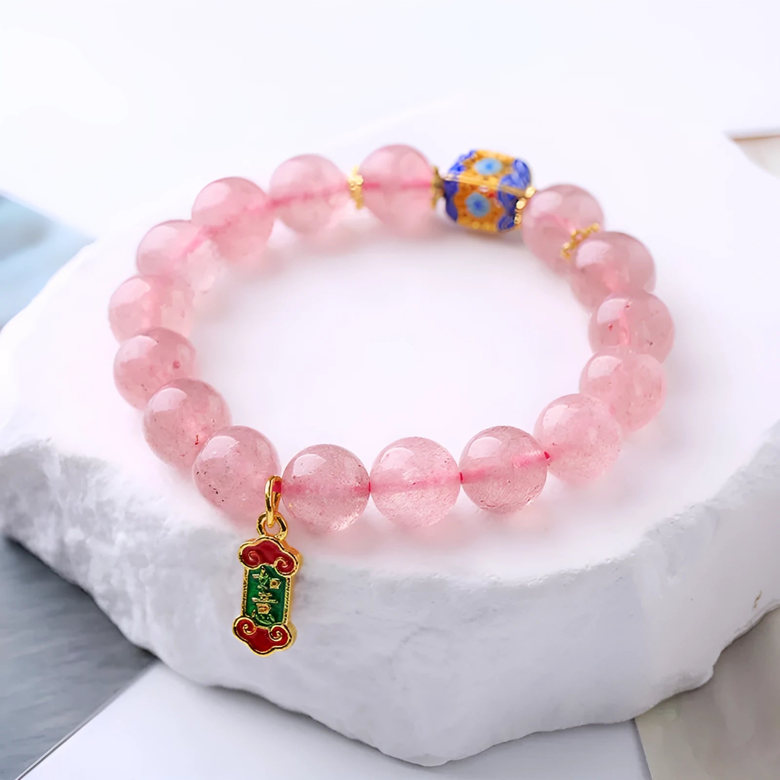 Pink strawberry quartz crystal bracelet with Ruyi charm, hand-woven in a national style.