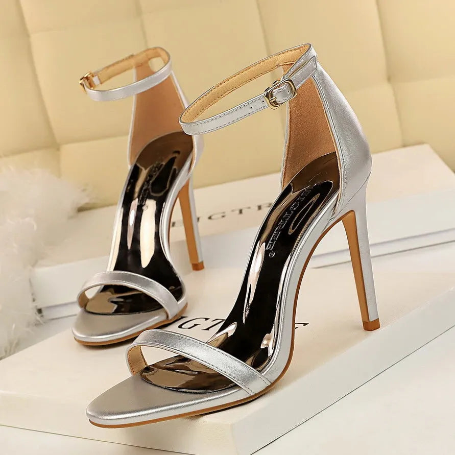 Women's open toe high heels with an ankle strap buckle in six colour options on a white background.