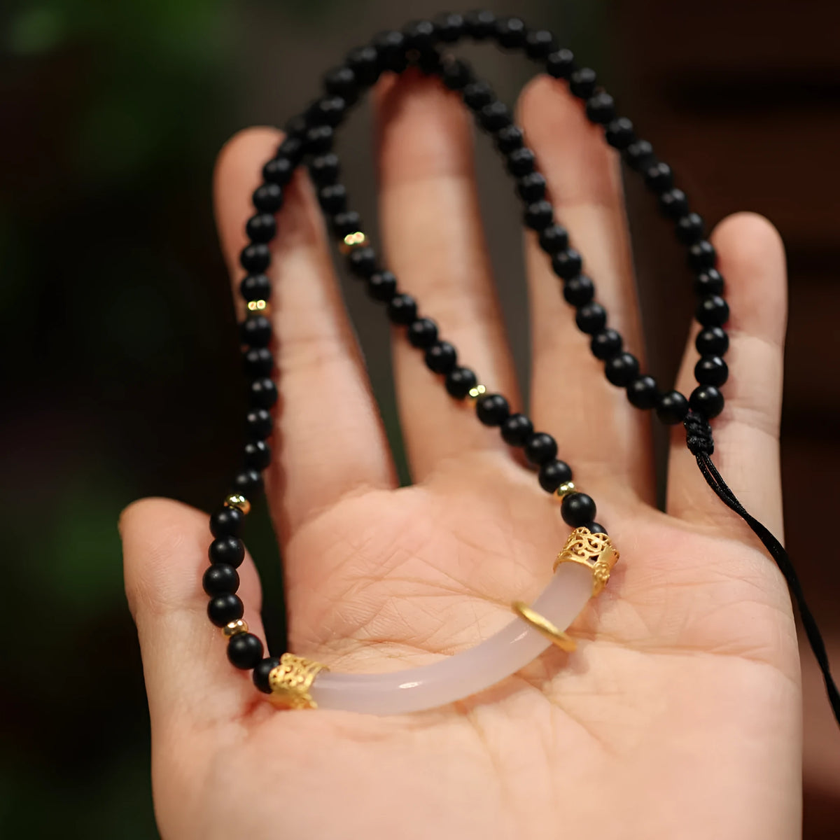 Women's Chinese style necklace with matte black agate pendant and silver ball bead chain.