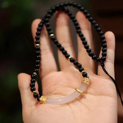 Women's Chinese style necklace with matte black agate pendant and silver ball bead chain.