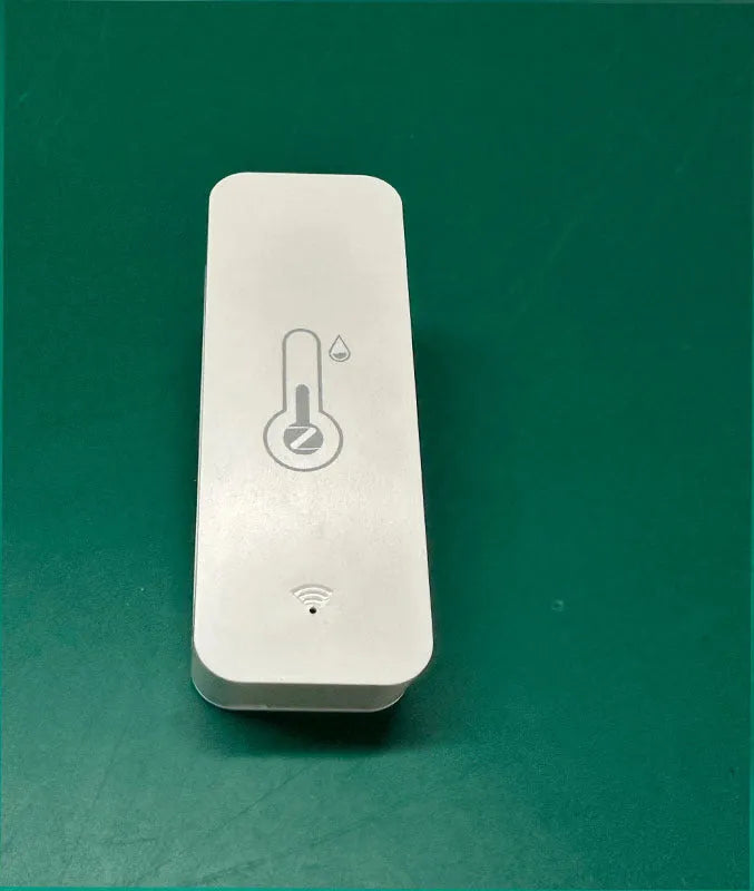 Compact white WiFi temperature and humidity sensor for smart home monitoring.