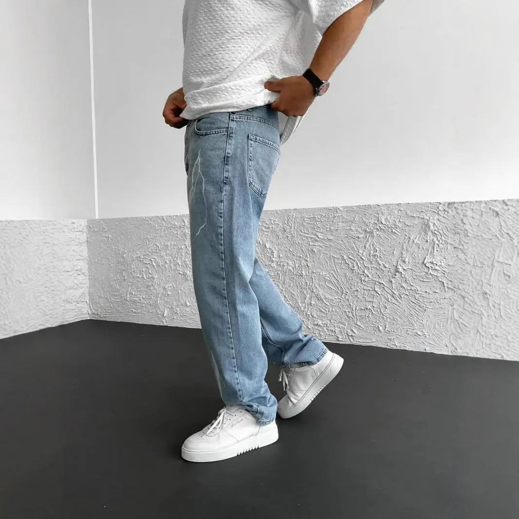 Men's blue straight-leg denim trousers with mid-waist design and zipper fly closure