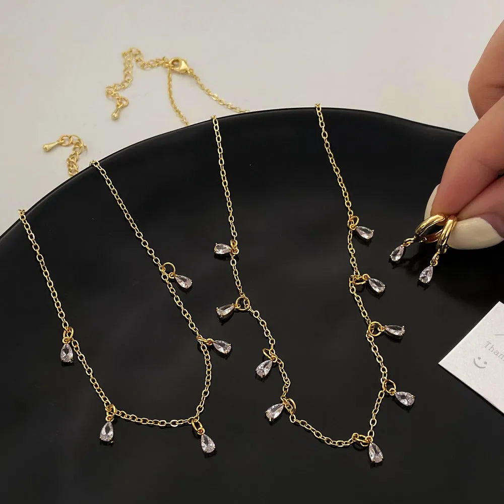 Women's zircon jewellery set showing geometric meteor shower design on necklace, earrings, and anklet