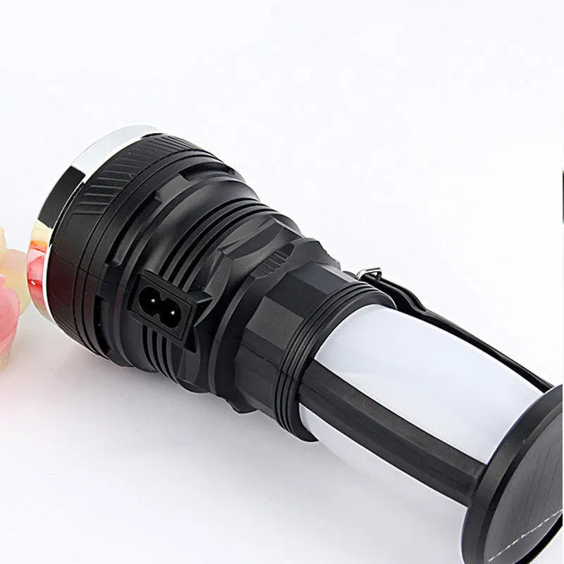 Black solar-powered LED emergency flashlight with USB charging port and press switch.