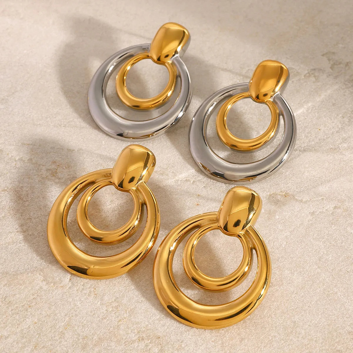 Round geometric hollow stud earrings in gold with 1.2cm diameter and centre cut-out design