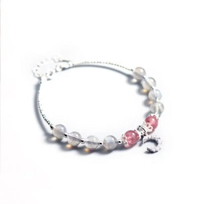 Natural moonlight-coloured moonstone bracelet with silver crescent moon charm on adjustable chain.