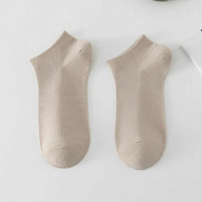 Pair of solid colour low-cut polyester boat socks for men, shown in one of six available colour options.