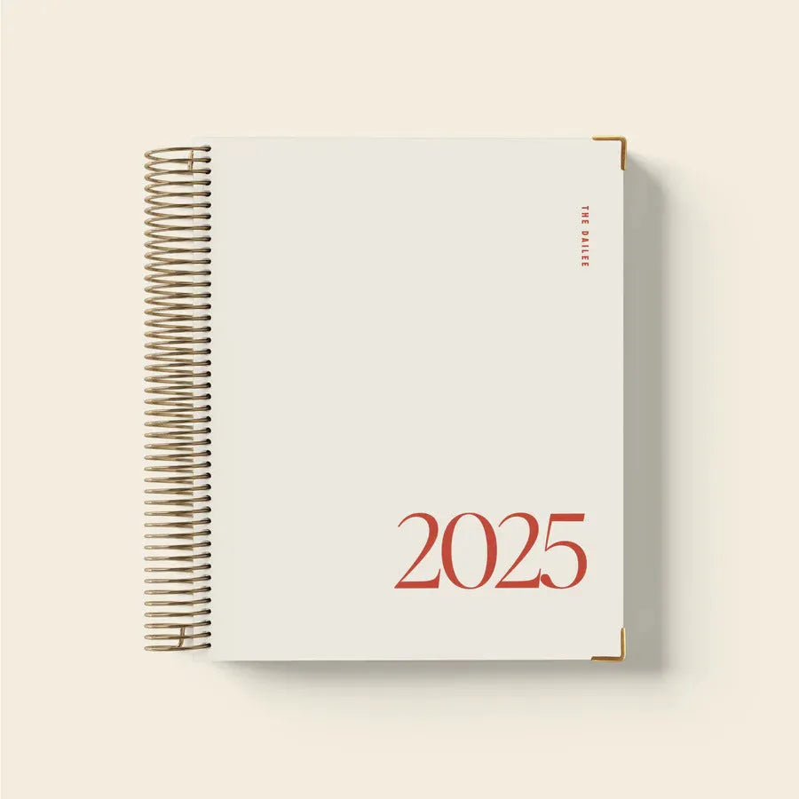 Cherry Red coloured A5 daily schedule coil notebook lying open on a surface.