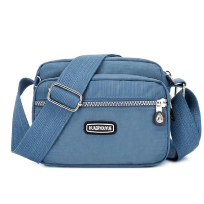 Compact nylon messenger bag in various colors with multiple compartments