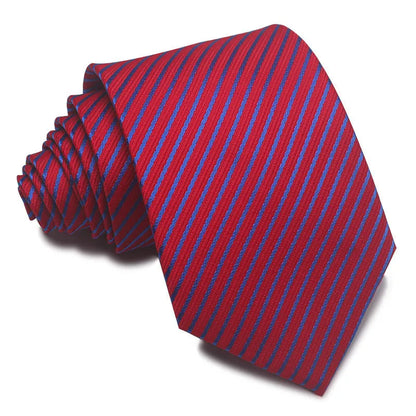 Close-up of a red and black striped jacquard weave tie with an arrow tip, showing texture.