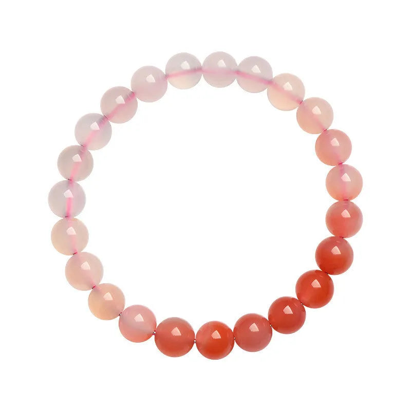 Natural gradient Yanyuan agate bracelet with geometric beads on a white background.