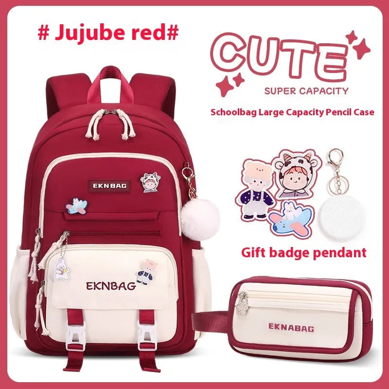 Pink waterproof Oxford cloth school backpack for girls with curved shoulder straps, shown with matching pencil case.