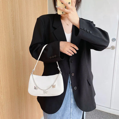 Women's black PU leather chain crossbody bag with butterfly clasp and structured square silhouette