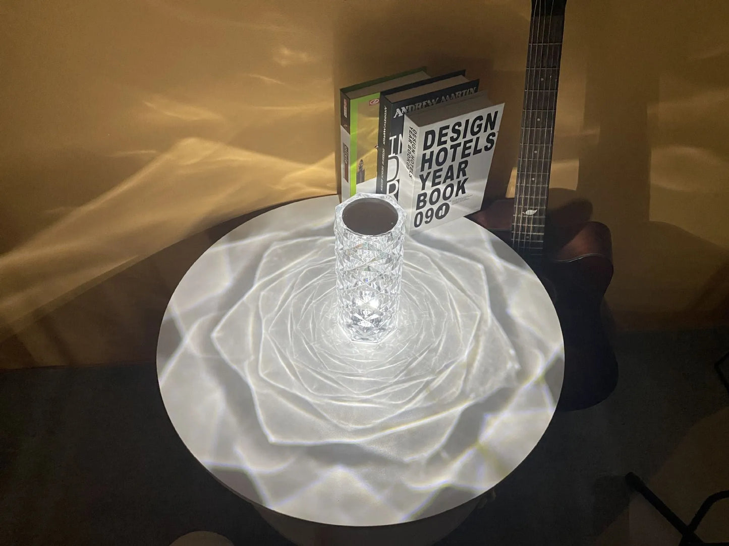 Modern minimalist acrylic crystal rose LED table lamp with touch switch on a wooden table.