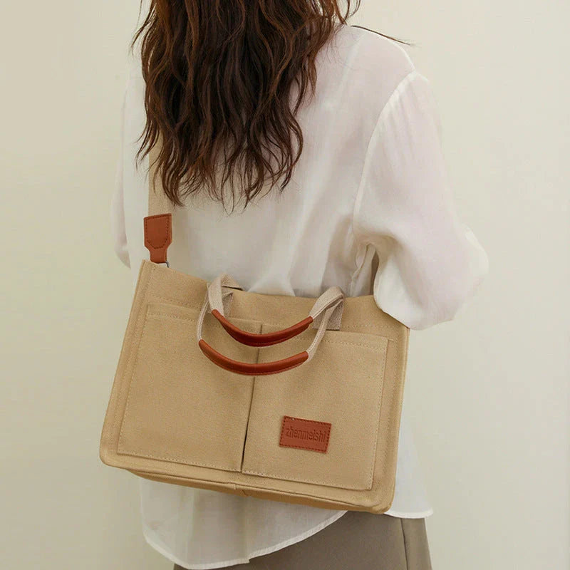 Premium canvas tote bag in multiple colors with adjustable shoulder strap and organizational pockets