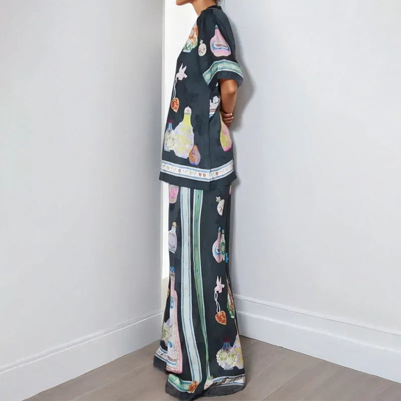 Black women's cardigan set with cartoon animation print, showing top with regular sleeves and matching trousers