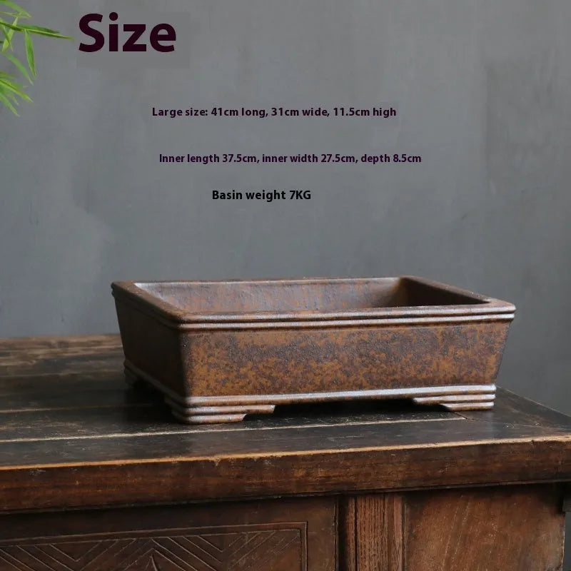 Purple sand rectangular bonsai pot with five-line design and firewood burning texture, shown with pine bonsai